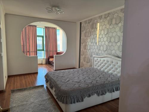 a bedroom with a bed and a large mirror at Актобе ажары in Aktobe