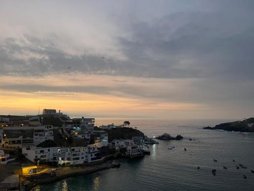 a group of buildings on the shore of a body of water at Departamento en malecon acogedor in San Bartolo