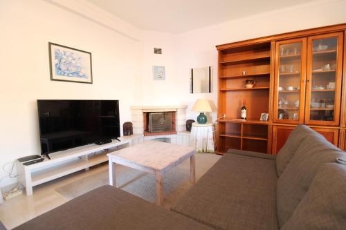 a living room with a couch and a television at Alcaria Grand House in Altura
