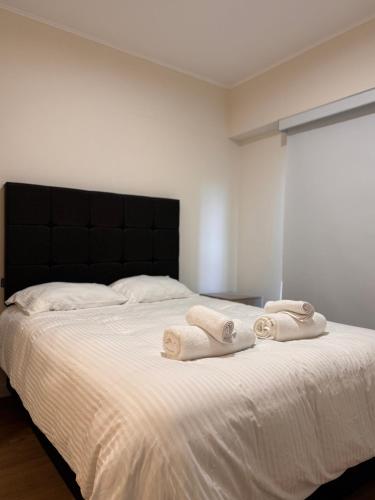 a bedroom with a bed with towels on it at Modern apartment in Lima in Lima