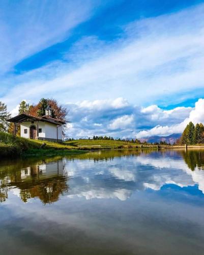 a house on a hill next to a lake at Il nido in montagna Mountain Lake Iseo Hospitality in Bossico