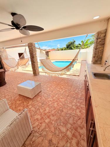 a living room with a hammock and a pool at Serenity House Antón in Coclé