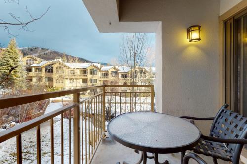 a table and chairs on a balcony with a view at Dulany 306 in Steamboat Springs