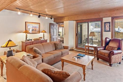 a living room with couches and chairs at Dulany 306 in Steamboat Springs