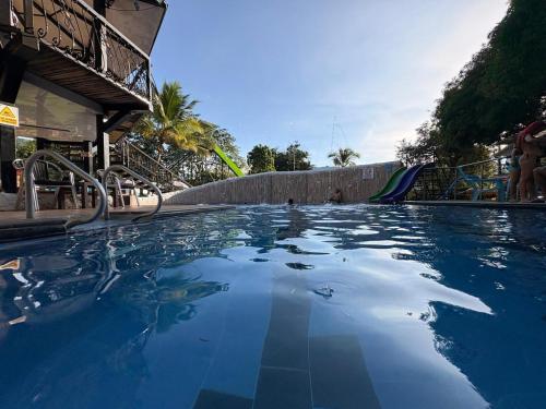 a large swimming pool with blue water at Finca Hotel Relax San Jerónimo in San Jerónimo
