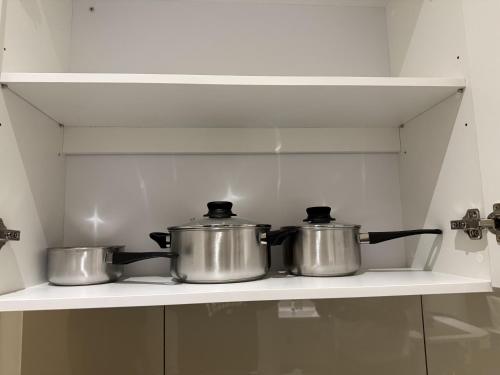 two pots sitting on a stove in a kitchen at Majestic Residance Luxury Suites By klcc in Gua Sai