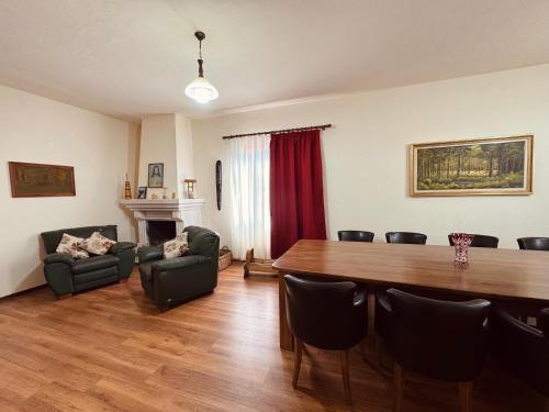 a living room with a dining room table and chairs at Bujtina Tushaj in Lezhë