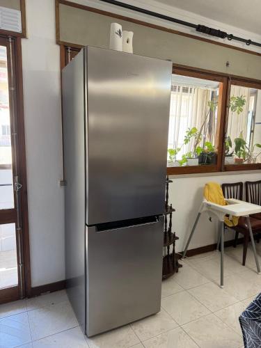 a large stainless steel refrigerator in a kitchen at Family & Pet Friendly Beach Stay & Fast Wi-Fi in Figueira da Foz