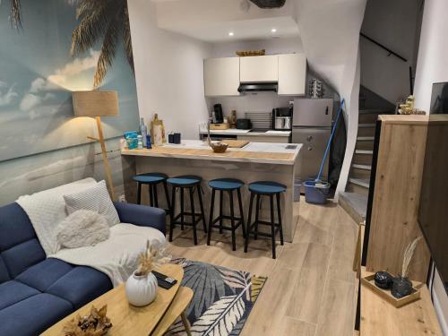 a living room with a couch and a kitchen at L'horizon De Coursan in Coursan