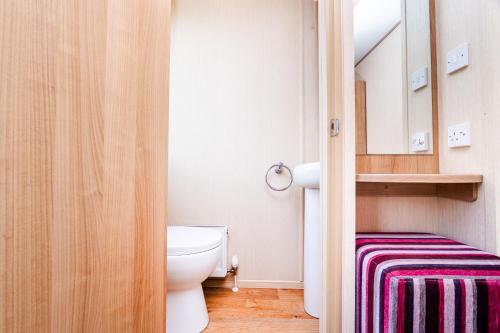 a bathroom with a toilet and a sink at 3 Bedroom Static Caravan-Seton Sands in Port Seton