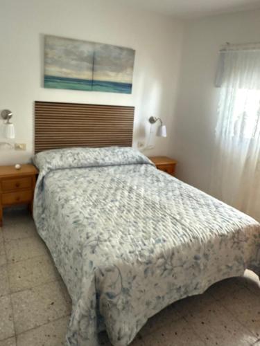 a bedroom with a large bed and a window at Casa Sole in El Médano