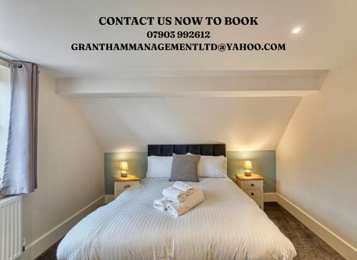 a bedroom with a bed with two night stands at Harrow Croft, 2 Bed Apartment, St Johns, Worcester in Henwick