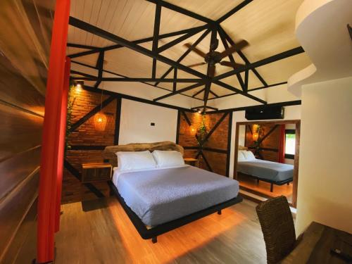 a bedroom with a large bed and a mirror at Buendía Lux Lotus Suite Hidden Gem Near Beach with Pool in Potrero