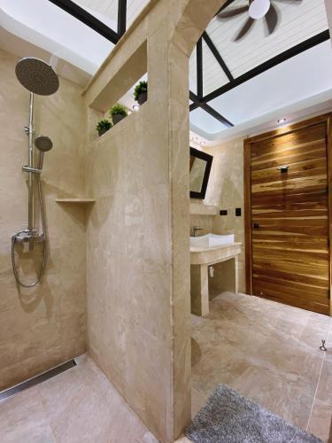 a bathroom with a shower and a sink at Buendía Lux Lotus Suite Hidden Gem Near Beach with Pool in Potrero