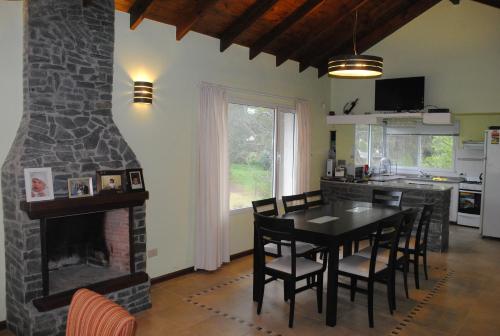 a kitchen and dining room with a brick fireplace at Casa Mar de Ostende 3 Dormitorios 8 Pasajeros in Ostende