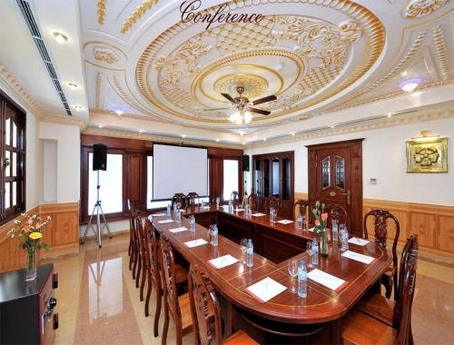 a large conference room with a long table and chairs at New Pacific Hotel in Ho Chi Minh City