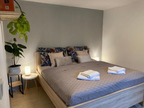 a bedroom with a bed with towels on it at Apartmán Lipno 1 in Lipno nad Vltavou