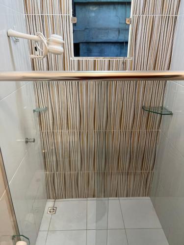 a bathroom with a shower with a mirror at Casa com suite bem localizada in Manaus