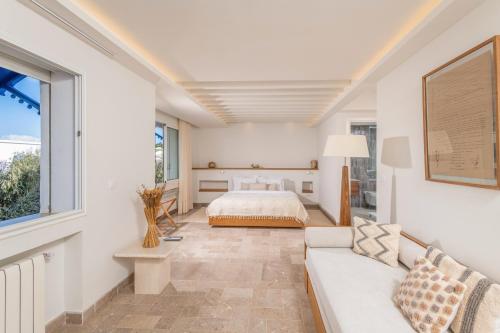 ein Schlafzimmer mit einem Bett und einer Couch in der Unterkunft Neira Boutique Hotel & Spa in Sidi Bou Saïd