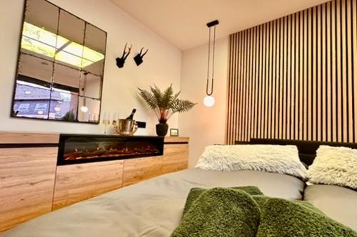 a bedroom with a bed and a fireplace at Ferienwohnung Harzurlaub II in Hahnenklee-Bockswiese