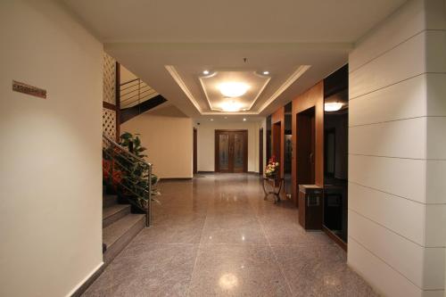 a hallway of a building with a staircase and a hallway sidx sidx sidx at Hotel Hyderabad Grand in Shamshabad