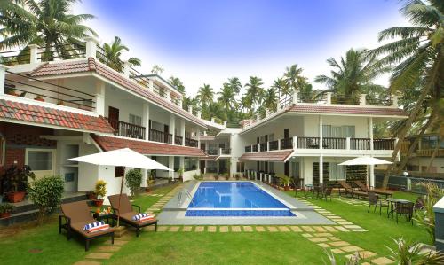 an exterior view of a house with a swimming pool at B'Canti Boutique Beach Resort in Varkala