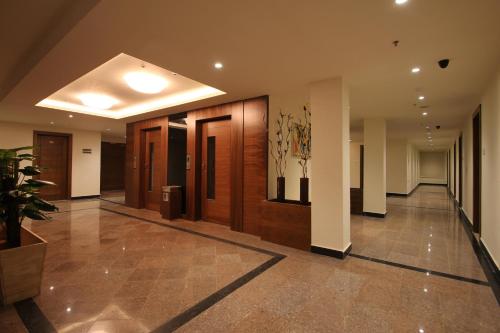 a hallway of a building with wooden doors at Hotel Hyderabad Grand in Shamshabad