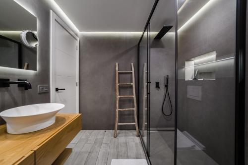 a bathroom with a sink and a glass shower at White Haven in Adeje