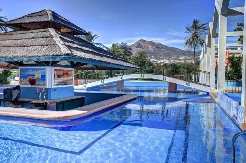 a pool at a resort with a drink fountain at Apartamento Benalbeach in Benalmádena