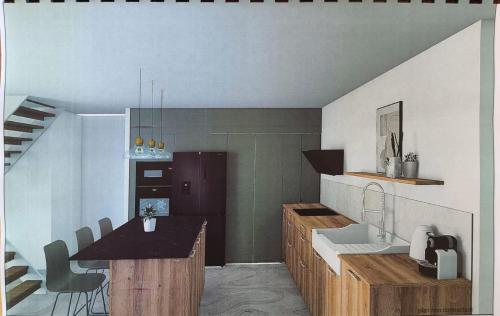 a kitchen with a sink and a counter top at Gîte Beauséjour in Saint-Aubin-de-Luigné