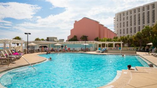 una piscina in un hotel con persone sedute intorno di Tides 611 a Destin