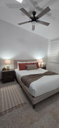 a bedroom with a large bed with a ceiling fan at Boho Chic Relaxing Space in Fajardo