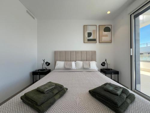 a bedroom with a large bed with two pillows on it at Casa Verde in Molino de las Ánimas