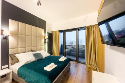 a bedroom with a bed with two towels on it at ANS Hanza Tower Apartment no 410 - Swimming pool and saunas not opened from 12-28 November in Szczecin