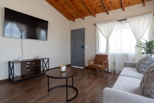 a living room with a couch and a table at NEW Casa Marea Beach Front House DT 2BR WiFi & AC in Colonia Cuauhtemoc