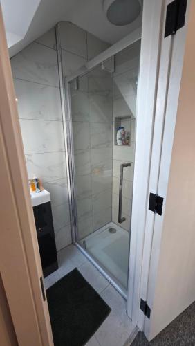 a small bathroom with a shower and a sink at Studio apartment in Fishponds in Bristol