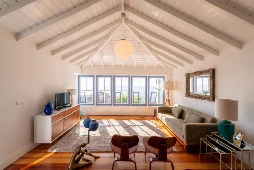 a living room with a couch and a table at T1 Casa das Pereiras in Calheta de Nesquim