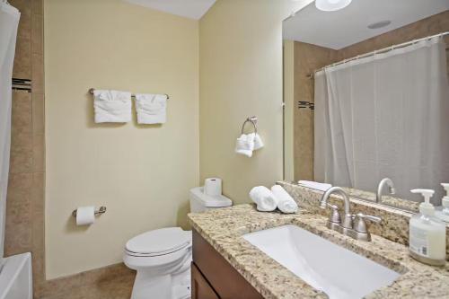 a bathroom with a sink and a toilet and a mirror at Entertaining 5 Bedrooms Luxury DC Vibe in Springfield