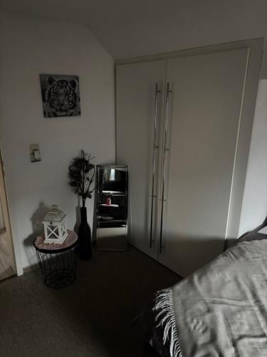 a kitchen with a refrigerator and a plant in a room at Dein Zuhause auf Zeit! in Güster