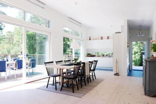 a kitchen and dining room with a table and chairs at OGO730-Vikbolandet-Vaerldens-Aende-46 in Arkösund