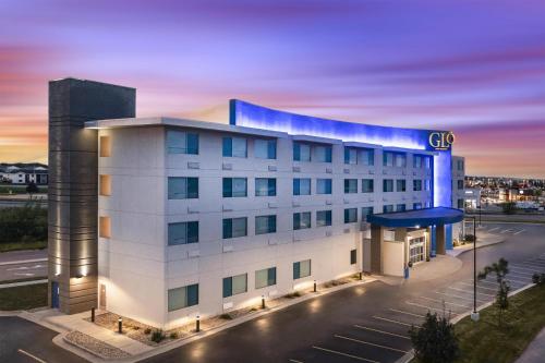 a building with a cgi sign on top of it at GLō Best Western Dawley Farms In Sioux Falls in Sioux Falls