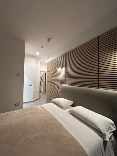 a bedroom with a large bed with a large headboard at International Naples in Naples