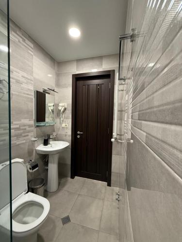 a bathroom with a toilet and a sink at Best view Kazbegi in Kazbegi