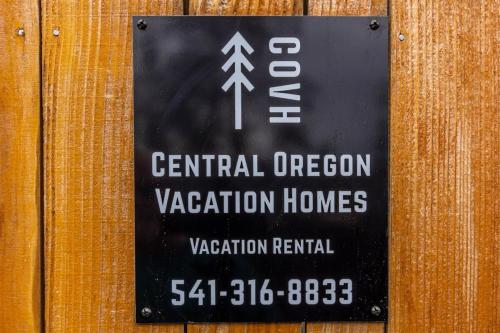 a sign on a wooden wall that reads central operation vacation homes at Cumberland Bungalow walking distance to downtown in Bend