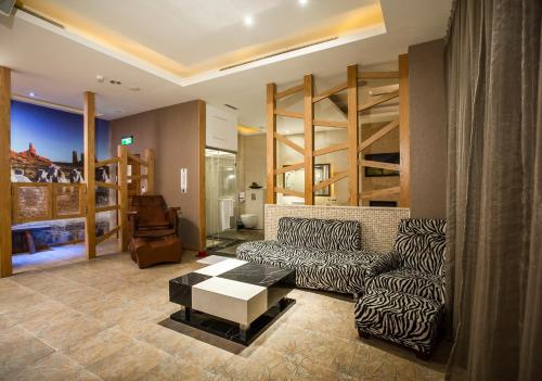 a living room with a couch and a table at Moon Area Motel in Douliu