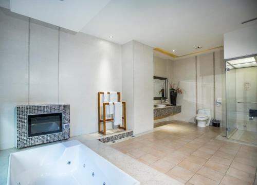 a large bathroom with a tub and a fireplace at Moon Area Motel in Douliu