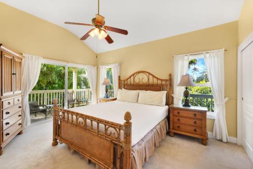 a bedroom with a bed and a ceiling fan at Regency 620 in Koloa
