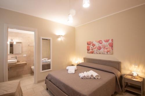 a hotel room with a bed and a bathroom at Terra Mater - Exclusive Cottage - in Ostuni