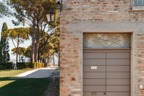 a garage door in the side of a brick building at Marica in Pesaro