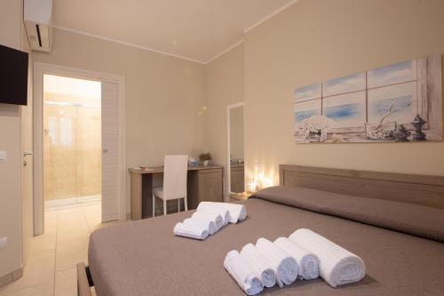 a bedroom with a bed with towels on it at Terra Mater - Exclusive Cottage - in Ostuni